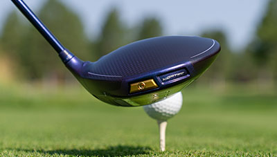 cavity view of G Le4 driver addressing ball on tee