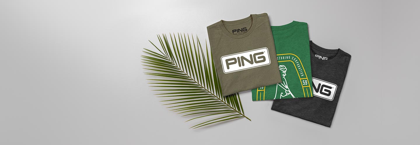 Image of three PING t-shirts folded by a palm leaf